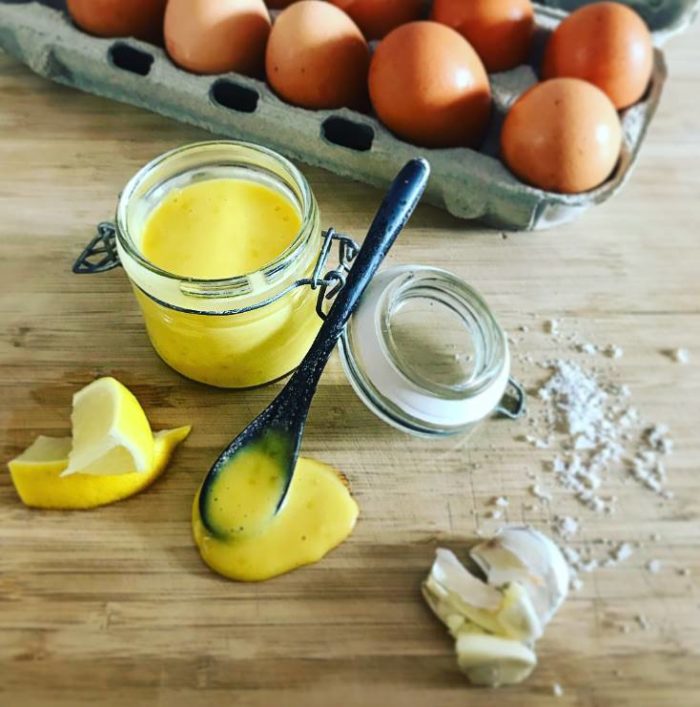 Homemade Aioli Aioli, eggs, garlic & lemon on chopping board
