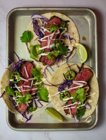 3 steak tacos - carne asada style on a tray