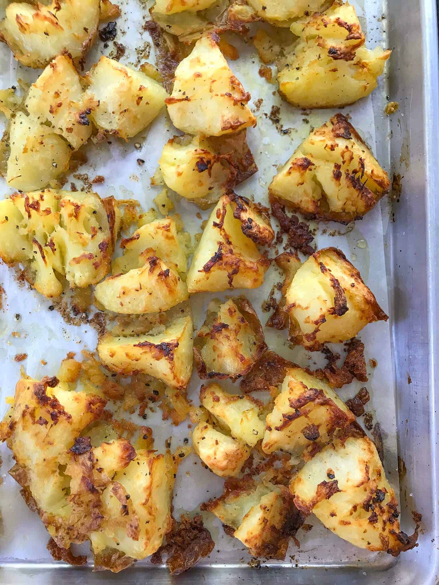 crispy smashed potatoes on a baking tray ready to eat