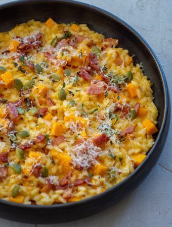 black bowl with pumpkin pork risotto in