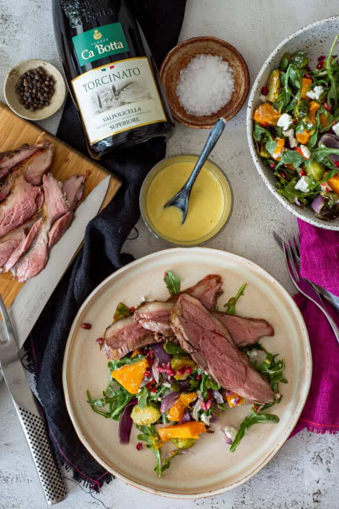 grilled lamb & veg salad, bottle of red wine and cooked sliced lamb