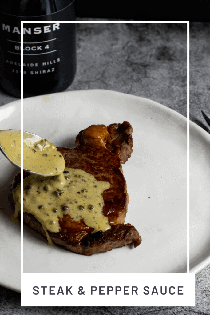 peppercorn sauce being spooned over steak & manser red wine