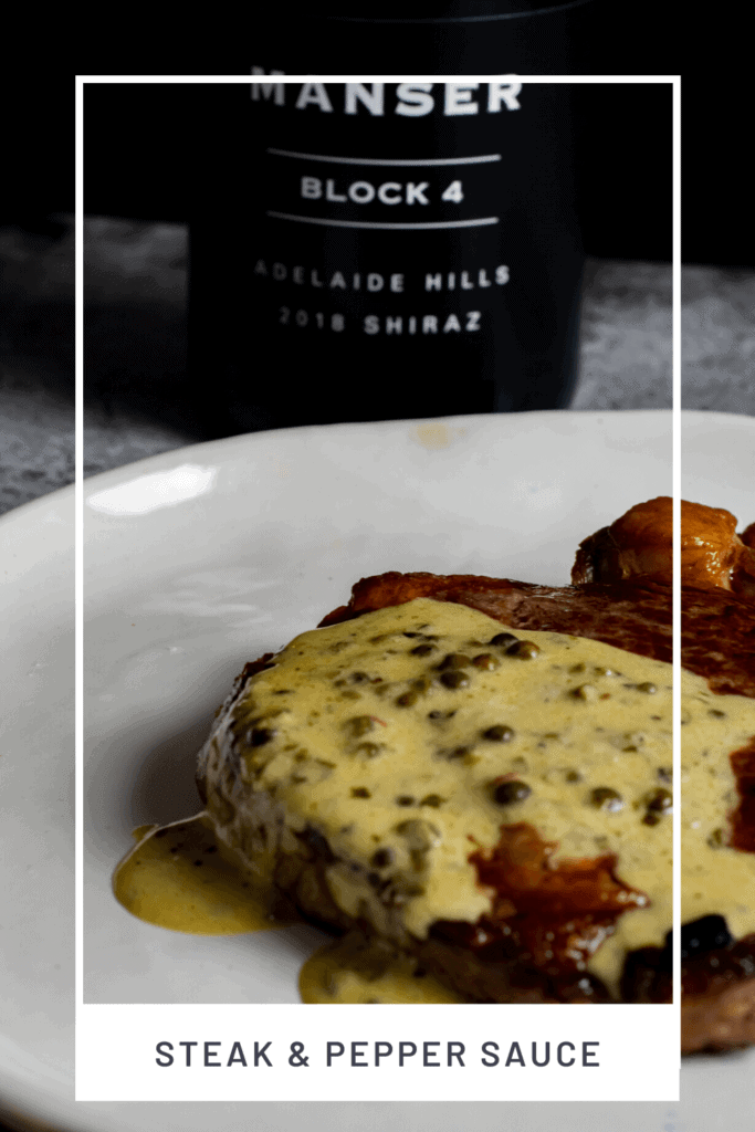 steak, peppercorn sauce on a plate with manser red