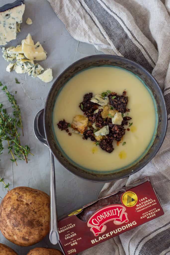 Potato & leek soup in a bowl, potato, thyme, blue cheese and black pudding on board
