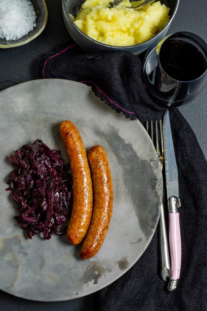 sausages, mashed potatoes and glass of red wine