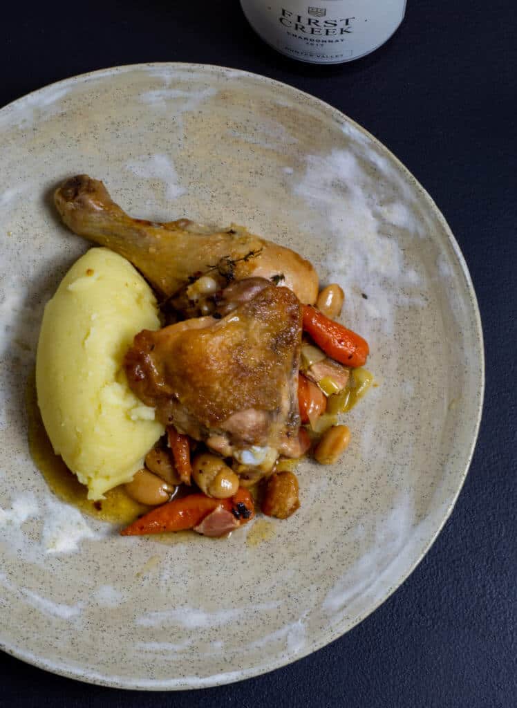 Chicken cassoulet & mashed potatoes on a plate