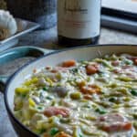 fish pie in pan with wine in background