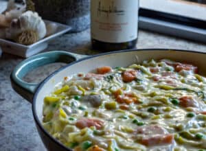 fish pie in pan with wine in background