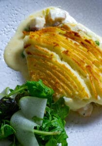 fish pie and salad on a plate