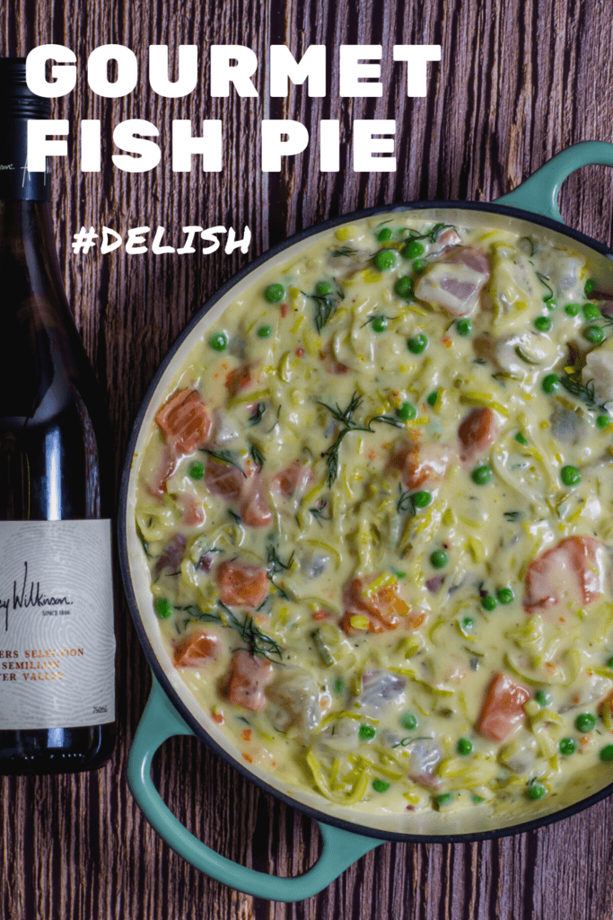 fish pie in pan with wine beside it