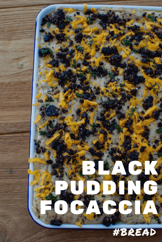 Black pudding focaccia in baking tray on wooden table