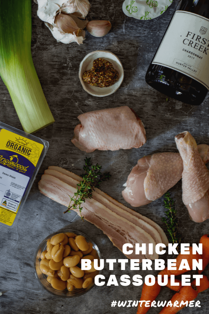 Ingredients for chicken cassoulet and a bottle of chardonnay