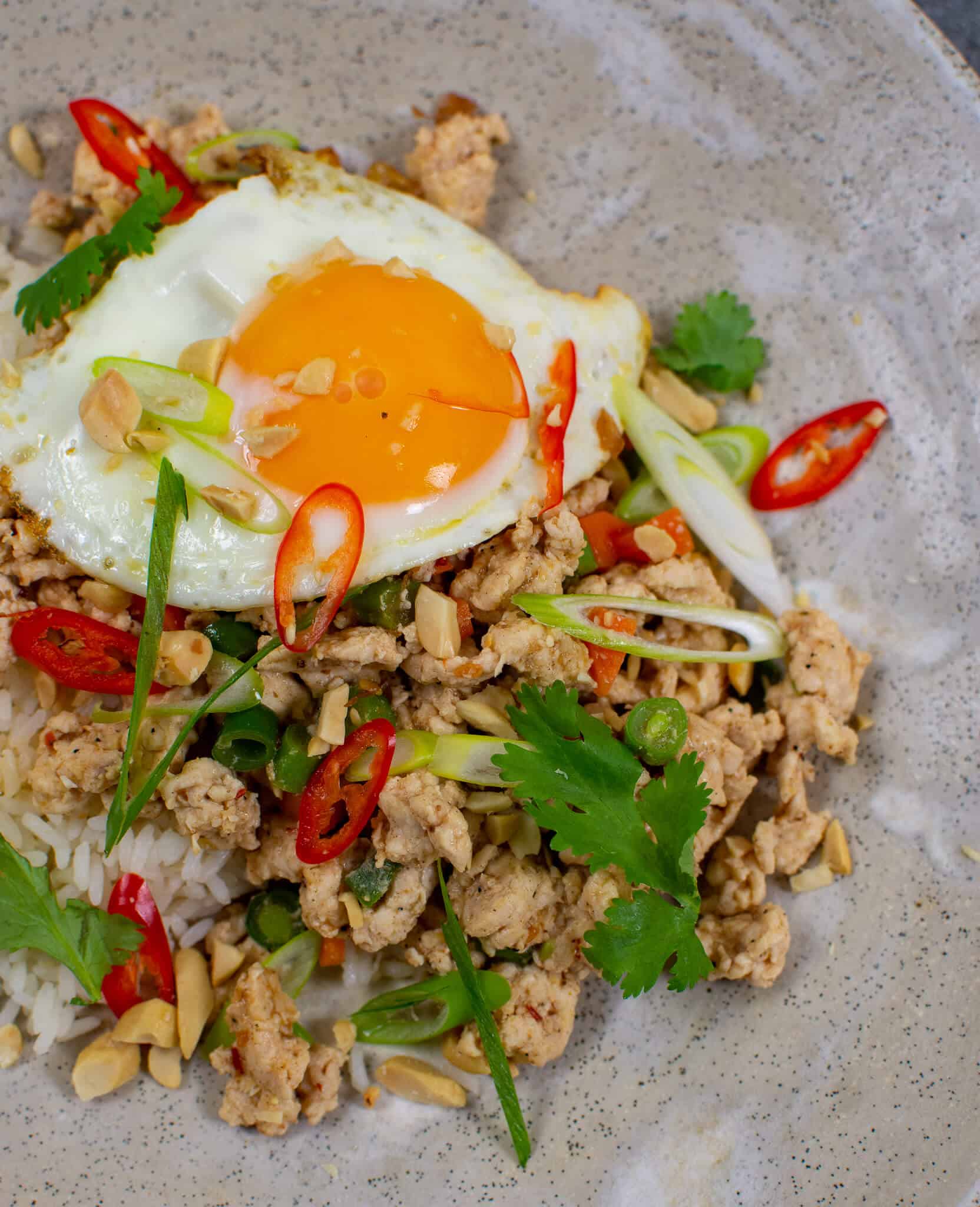 Szechuan fried chicken, rice and fried egg in a bowl