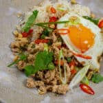 Szechuan fried chicken, rice and fried egg in a bowl