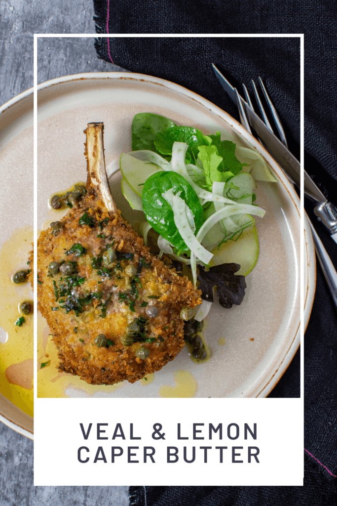 cooked veal cutlet, salad & sauce on a plate