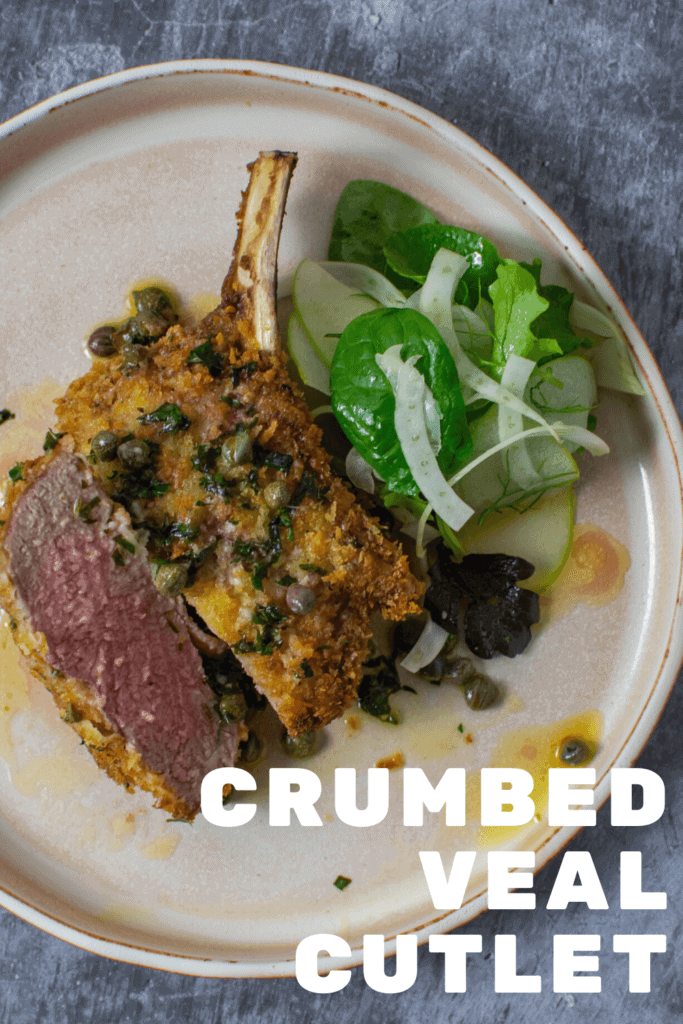 crumbed veal cutlet sliced in half with lemon caper sauce and salad