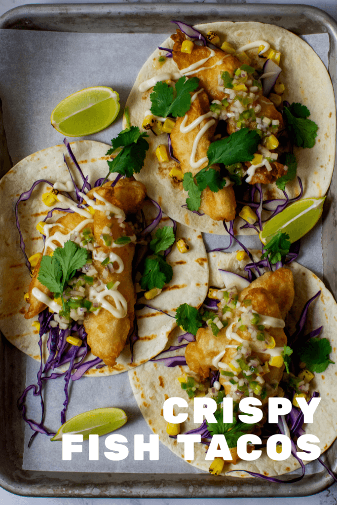 birdseye view of 3 crispy fish tacos on a tray