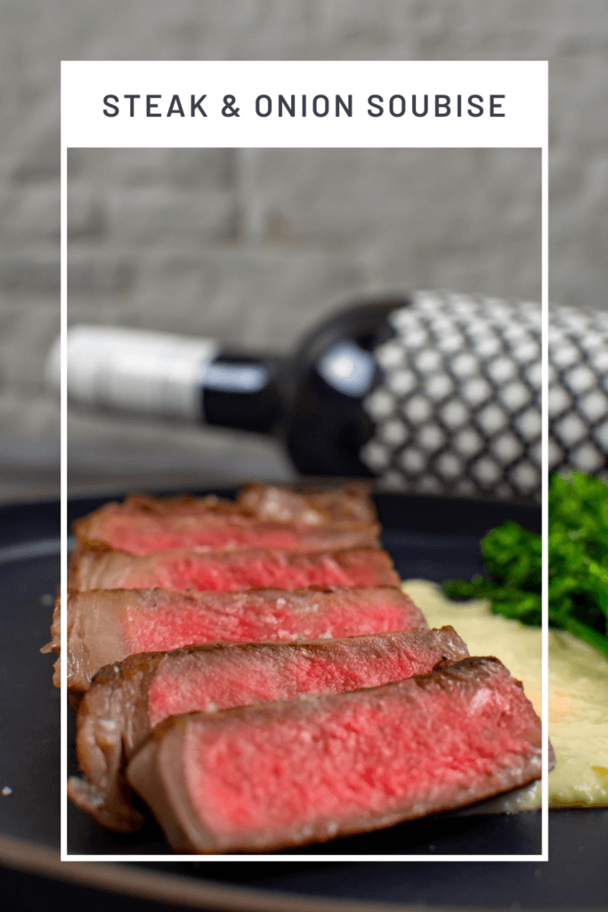 medium rare striploin on a plate. Bottle of heirloom shiraz in background