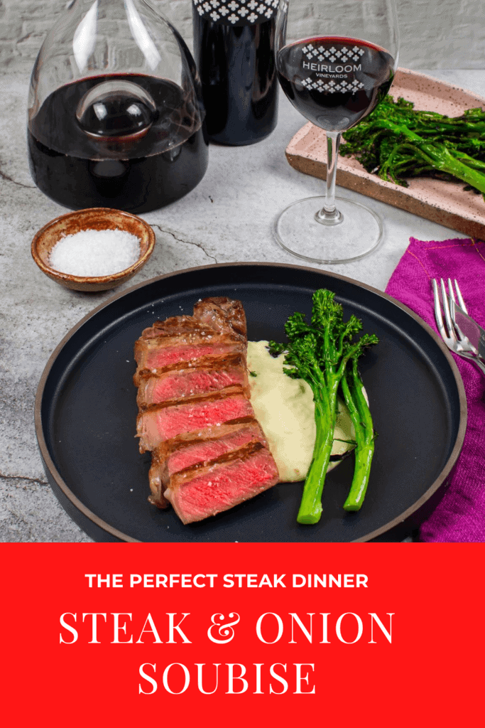 steak & onion soubise on a plate, decanter, glass of wine and bottle heirloom shiraz