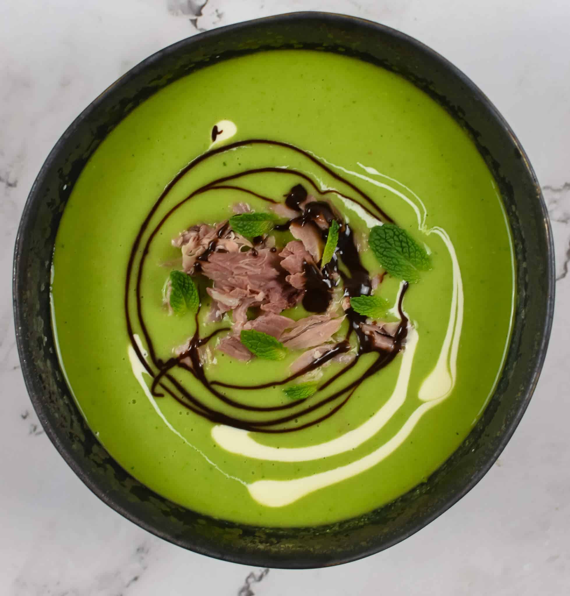 A bowl of pea & ham soup on kitchen countertop