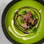 A bowl of pea & ham soup on kitchen countertop