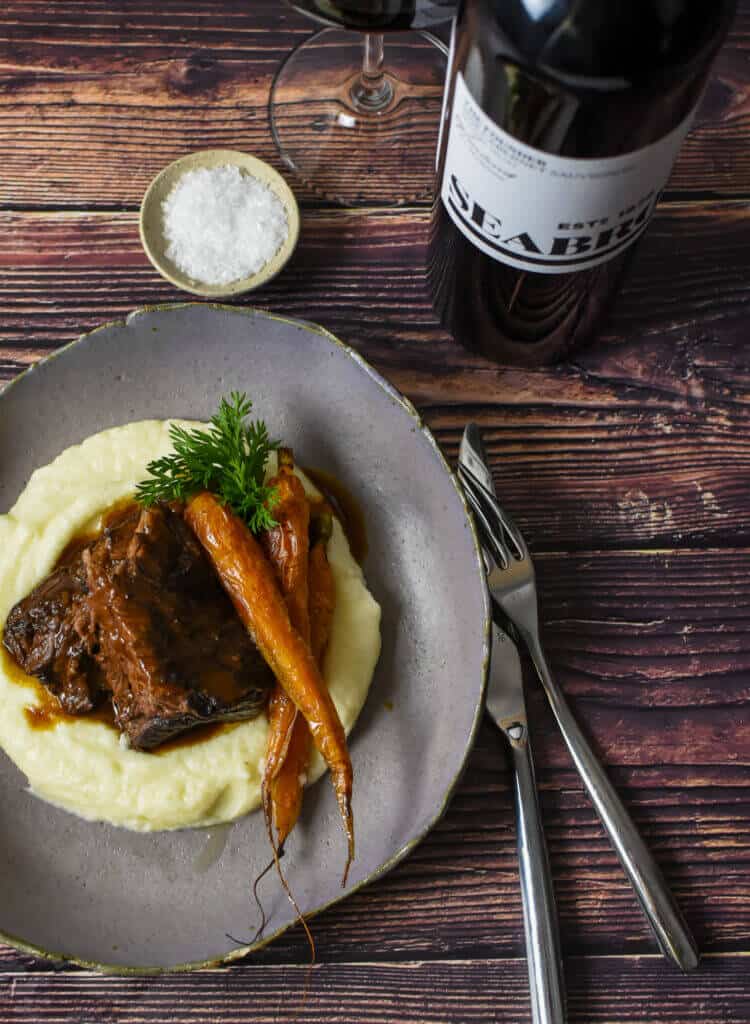 seabrook cabernet sauvignon, cutlery & bowl of mushroom braised short ribs