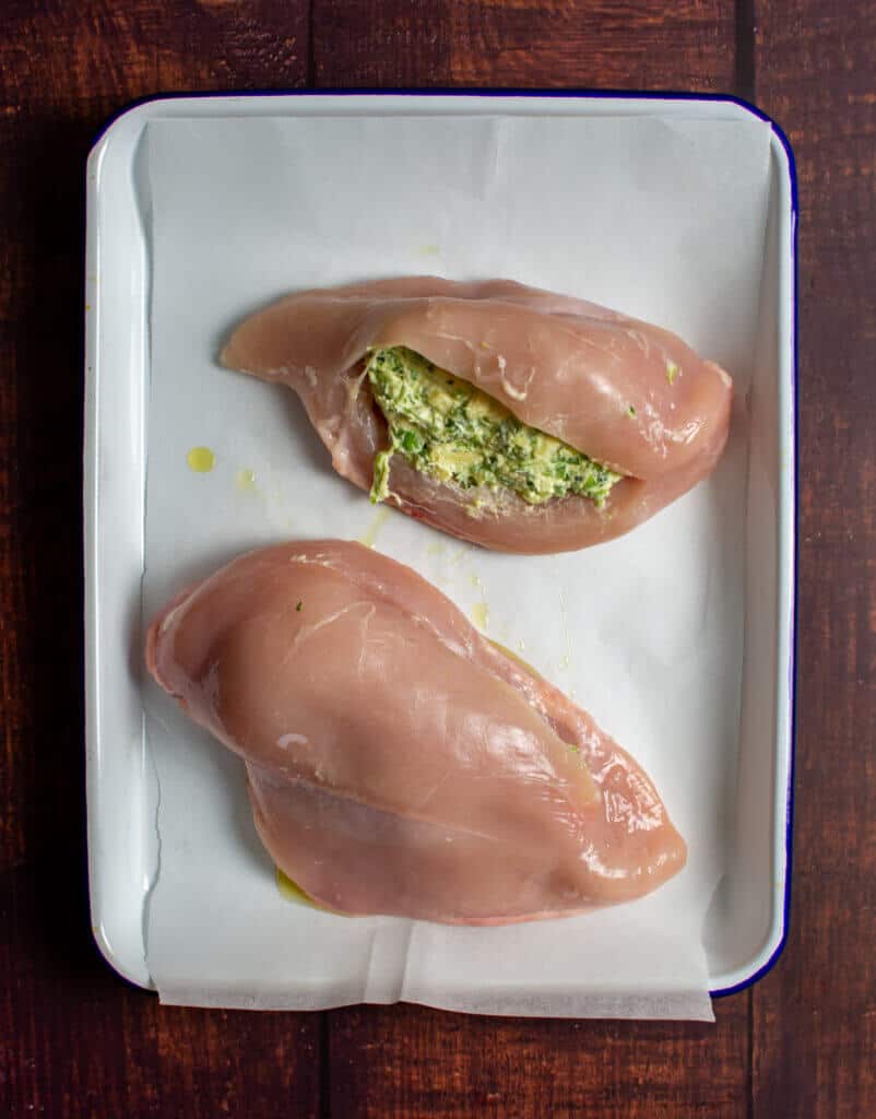 jalapeno popper stuffed chicken on a baking tray