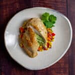 jalapeno popper stuffed chicken on white plate with corn hash