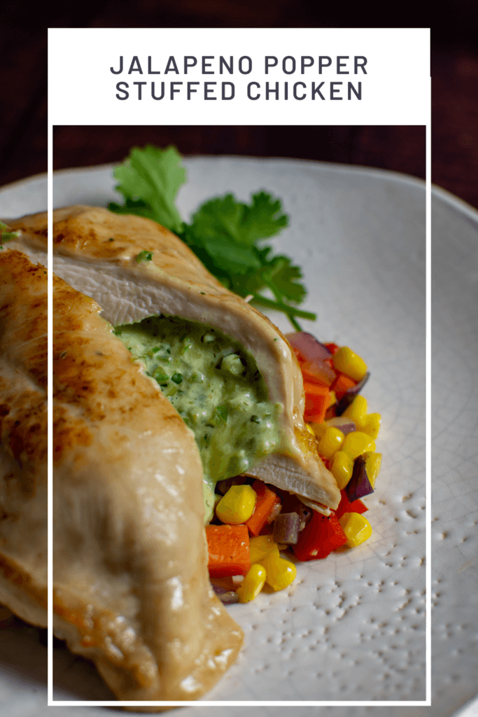 jalapeno popper stuffed chicken on white plate with corn hash