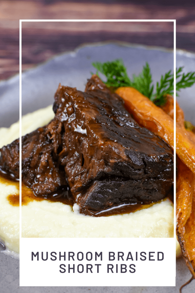 mushroom braised short ribs, cauliflower puree & carrots in a bowl on wooden table
