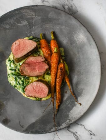 pork tenderloin, creamed spianch & carrots on a made of australia plate