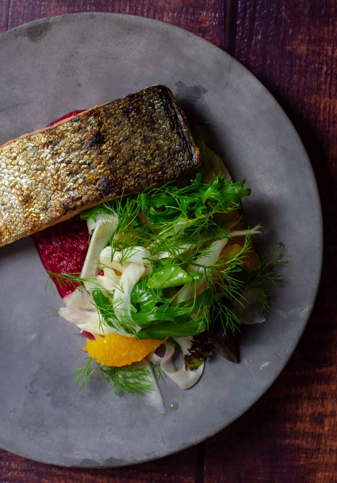 grilled salmon, beetroot hummus & fennel salad on a made of australia plate