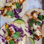 3 grilled fish tacos on a tray