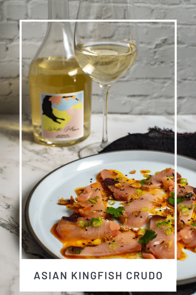 beautiful kingfish crudo on a CB2 plate, black napking and white gate wine co riesling