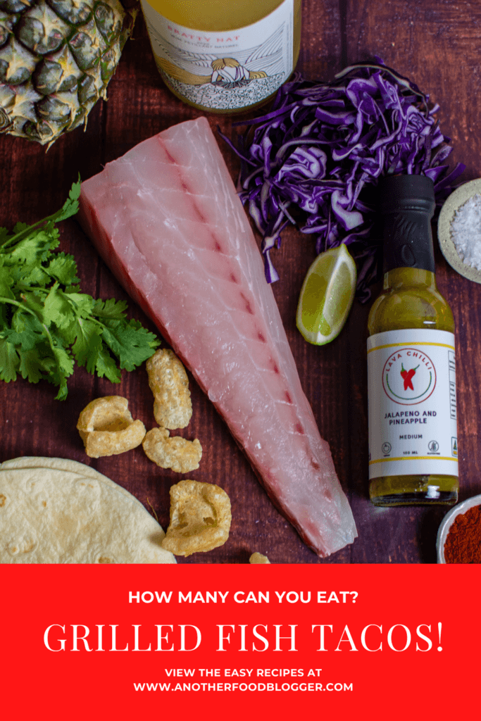 snapper, tortillas, pineapple, spices and red cabbage on a table