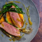 perfectly cooked duck breast, carrot puree & orange sauce on a made of australia plate