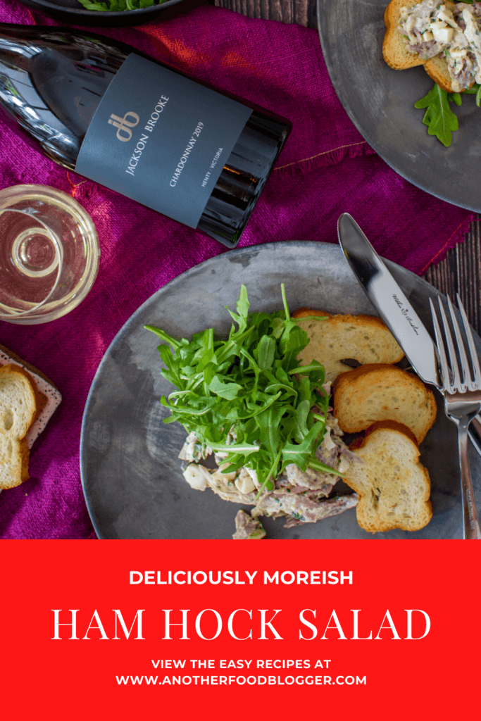 birds eye view of braised ham hock salad on made of australia plates, jackson brooke chardonnay on a wooden table