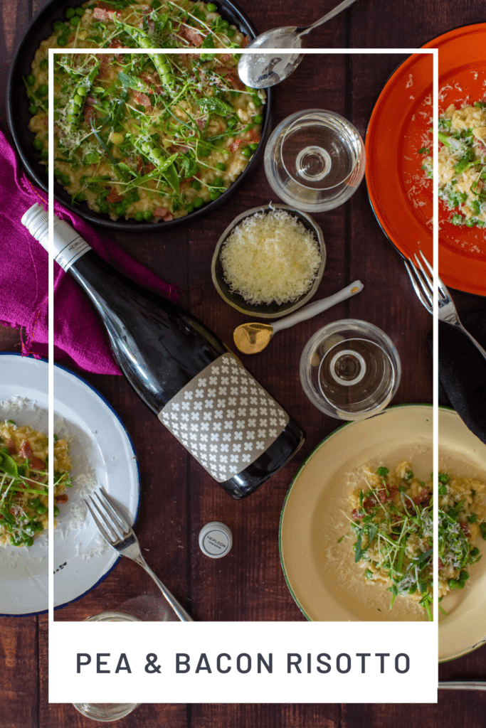 plates of pea & pacon risotto, heirloom chardonnay & wine glasses on a table