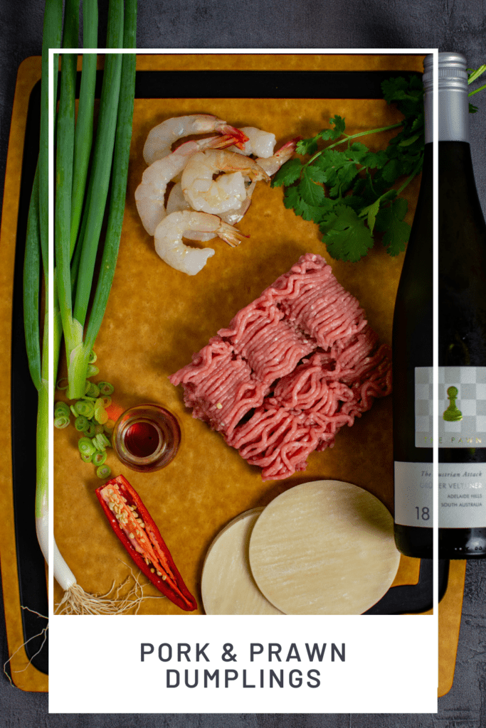 pork & prawn dumplings on a wooden chopping board with The Pawn Wine Co Gruner Veltliner