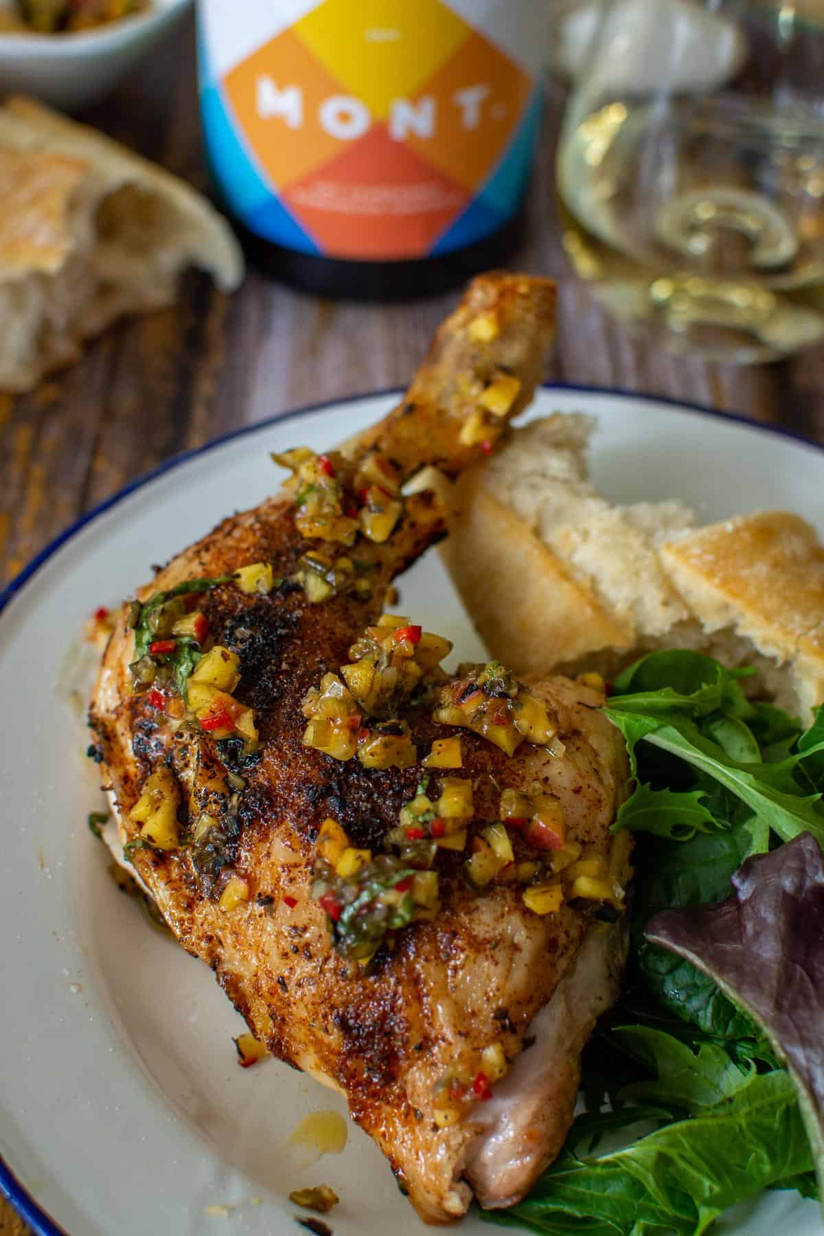 Mont wines, bbq spatchcock chicken & bread on a picnic table