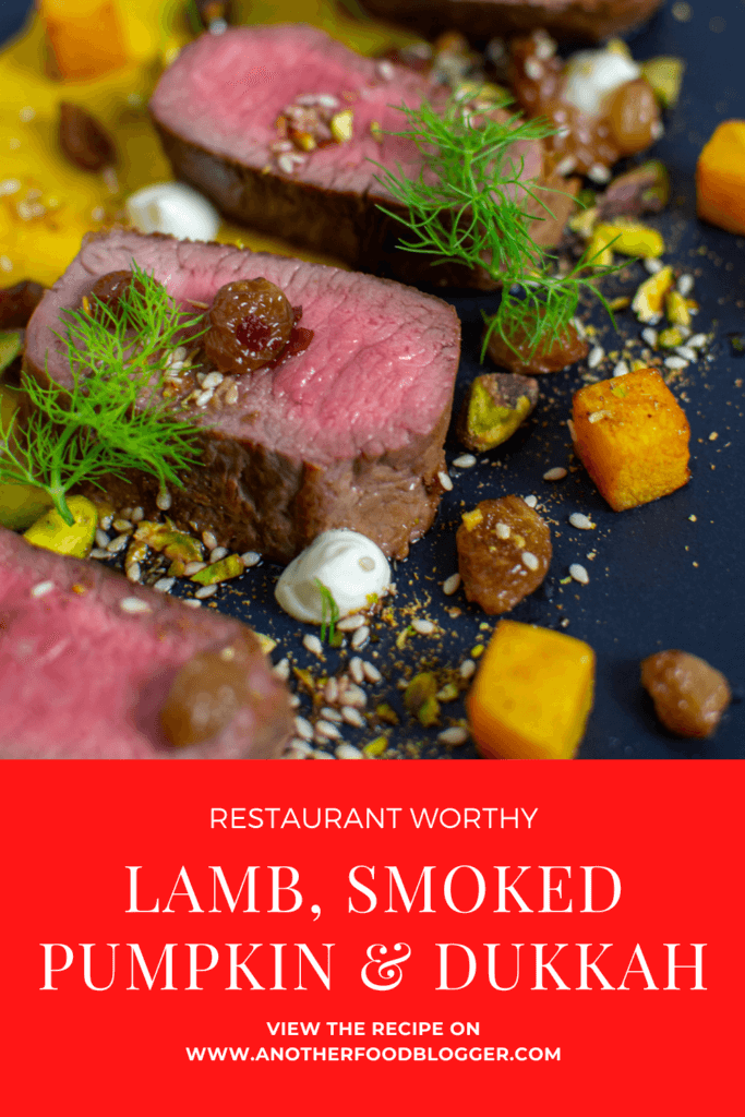 lamb, smoked squash puree, & pistachio dukkah on a black plate