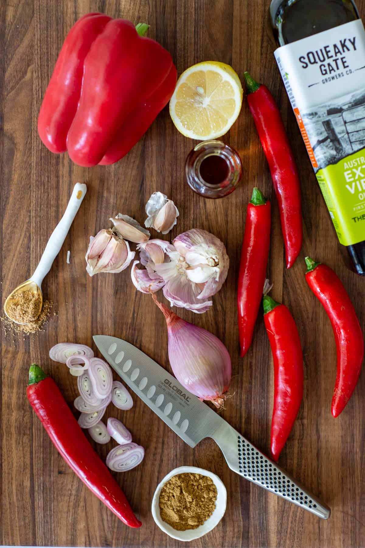 harissa ingredients on a chopping board and a global chef knife