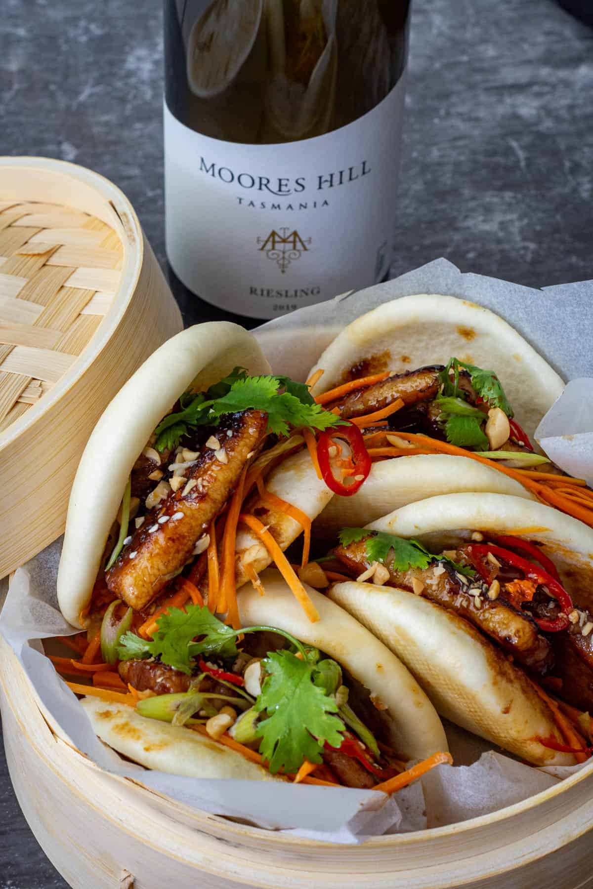 porn bao inside a bamboo steamer with moores hill riesling