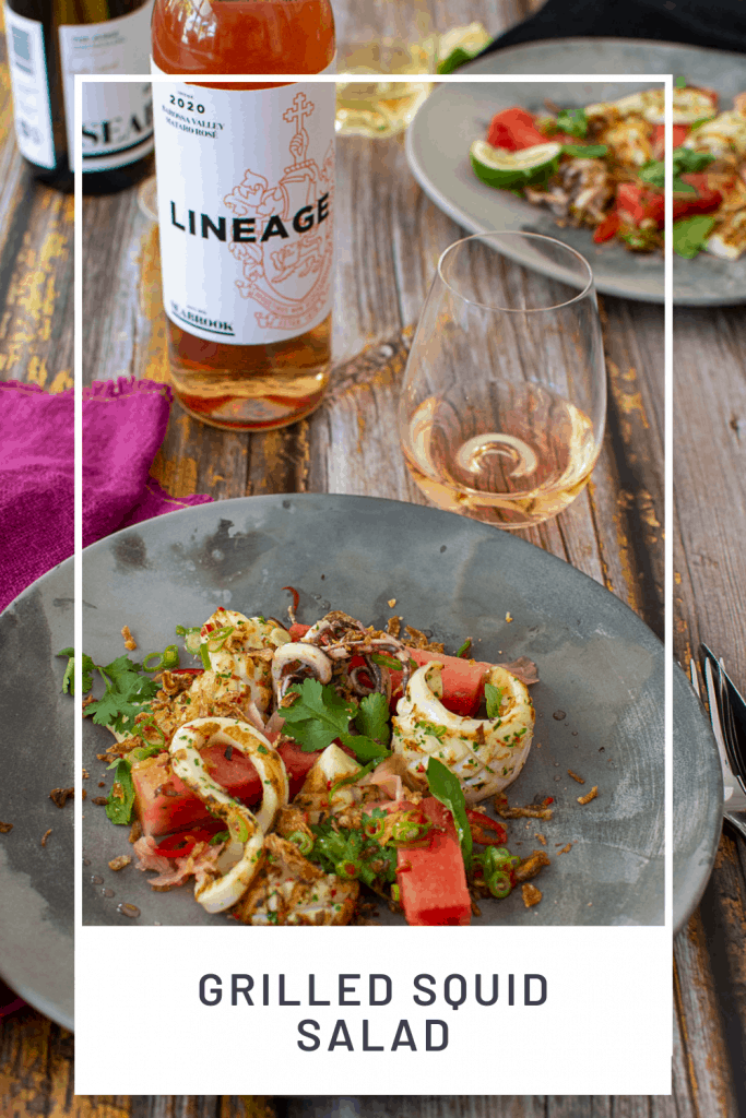 grilled squid salad on a plate with seabrook rose in background