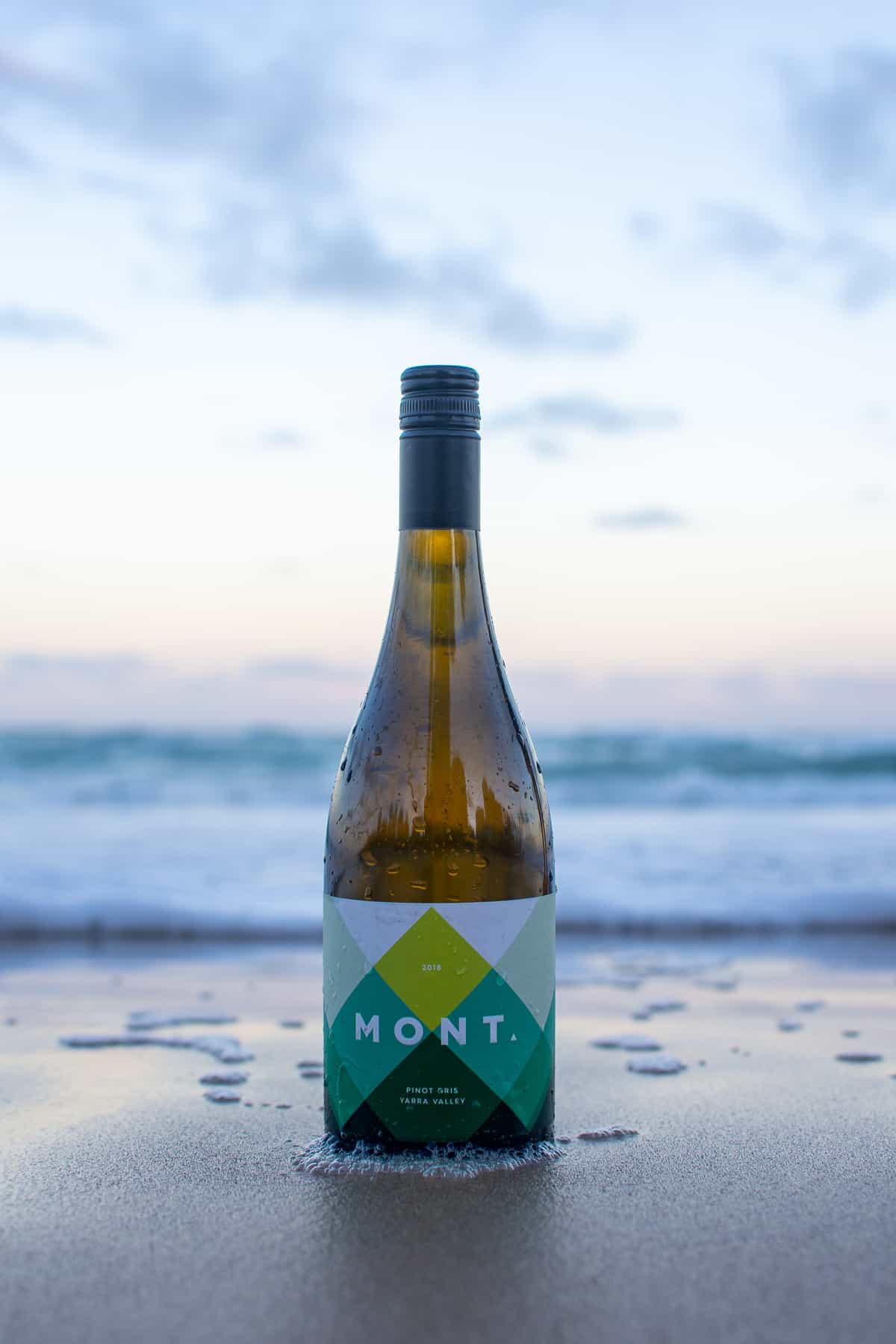 mont pinot gris bottle on the beach