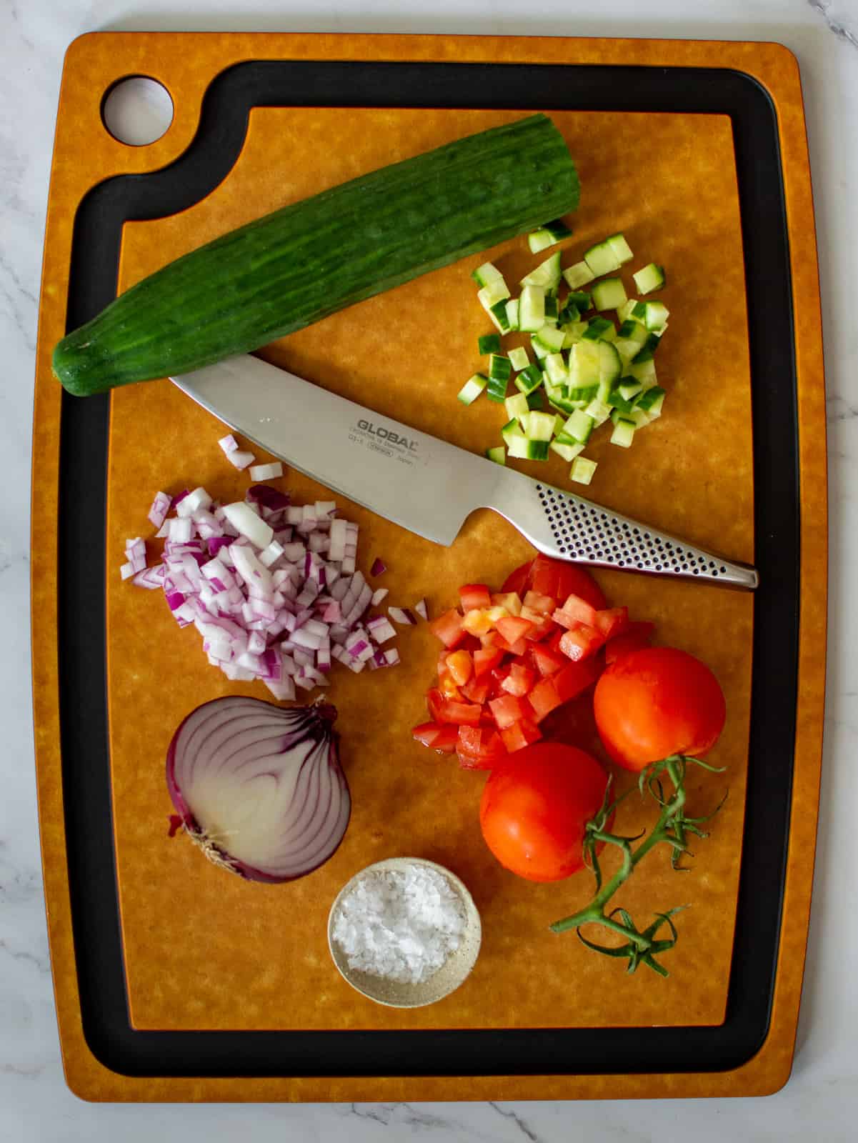 vegetables on a chopping board and a global chef knife