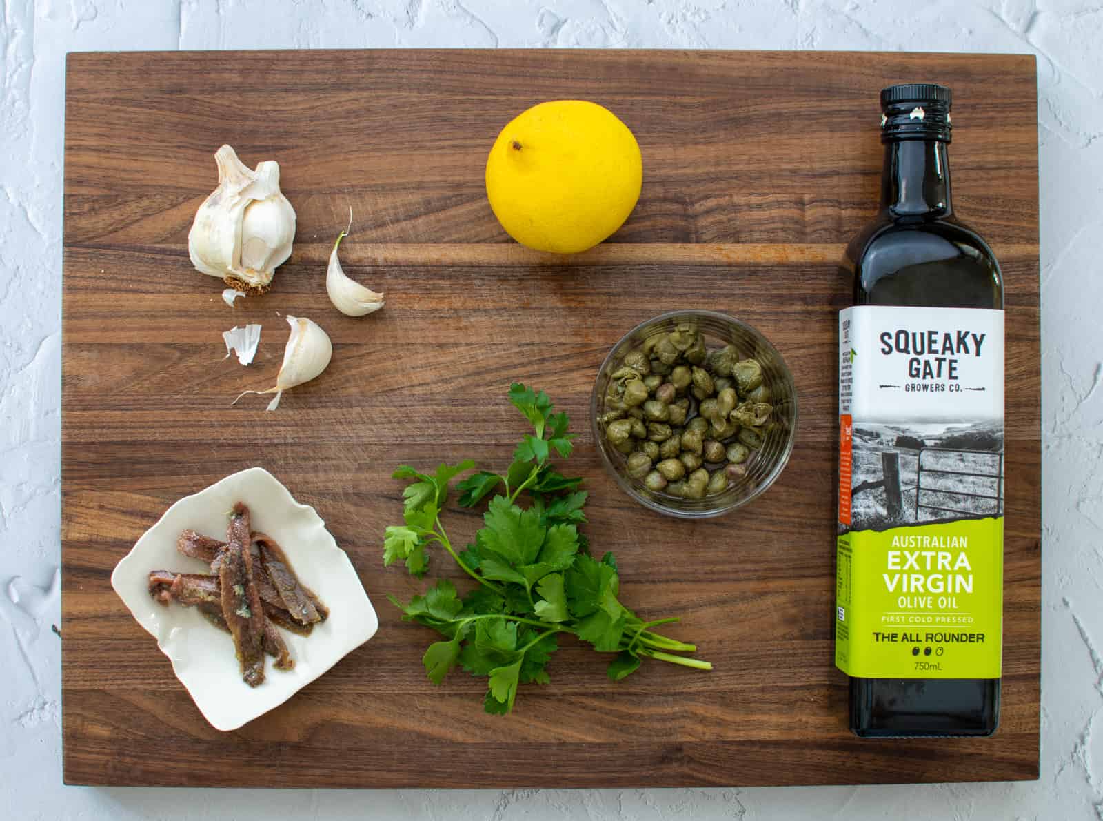 anchovy salsa ingredients on a chopping board