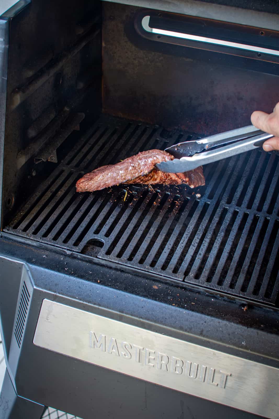 turning the steak on BBQ