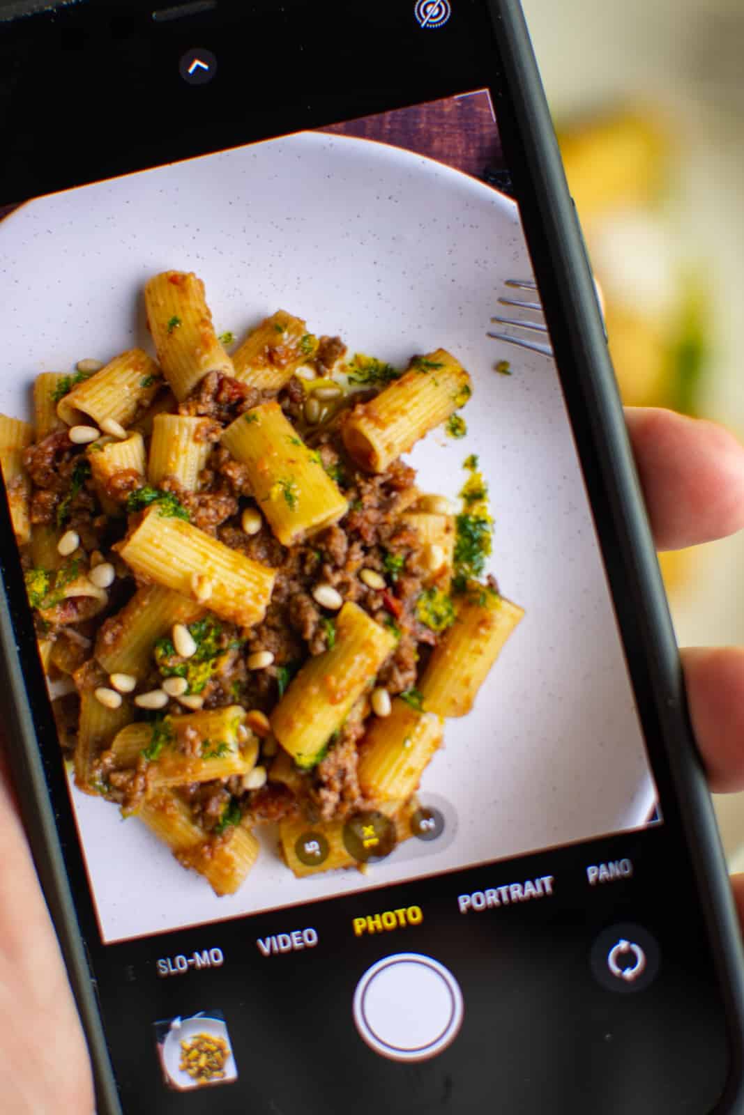 A photo of someone taing iphone photo of food