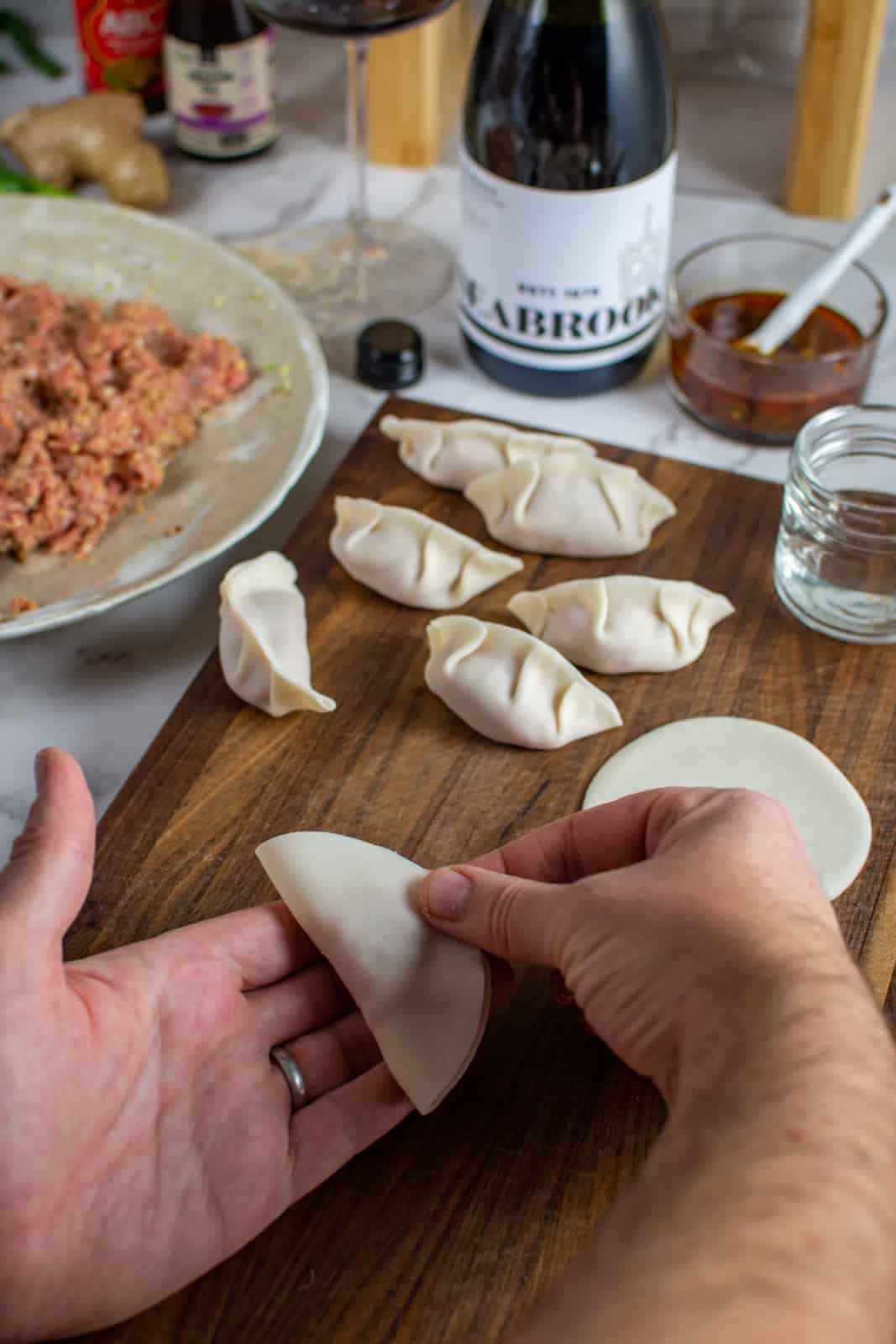 A dumpling wrapper being folded